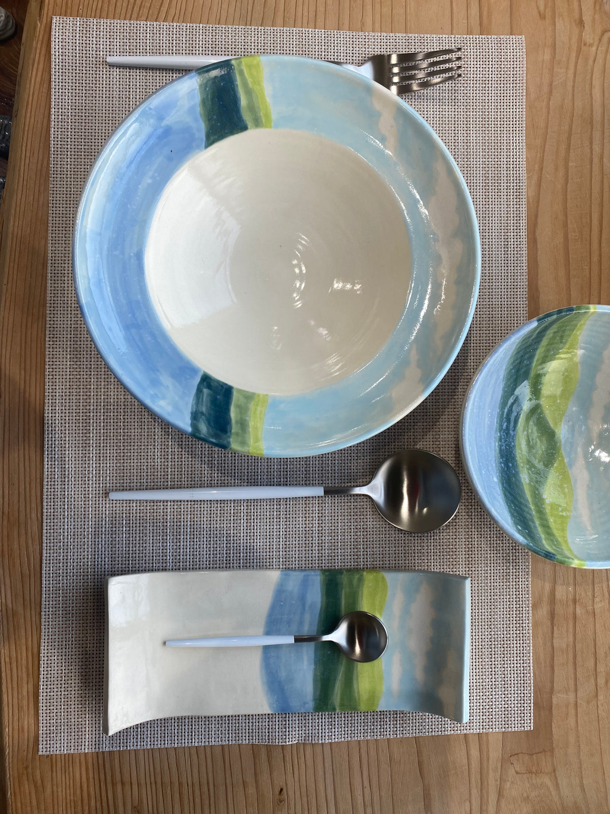 A hand decorated hand made Bowl and plate and side dish, a bright and happy set