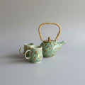 An elegent art nouveau tea set hand thrown, hand sculpted and finished in Celdon green with real gold lustre