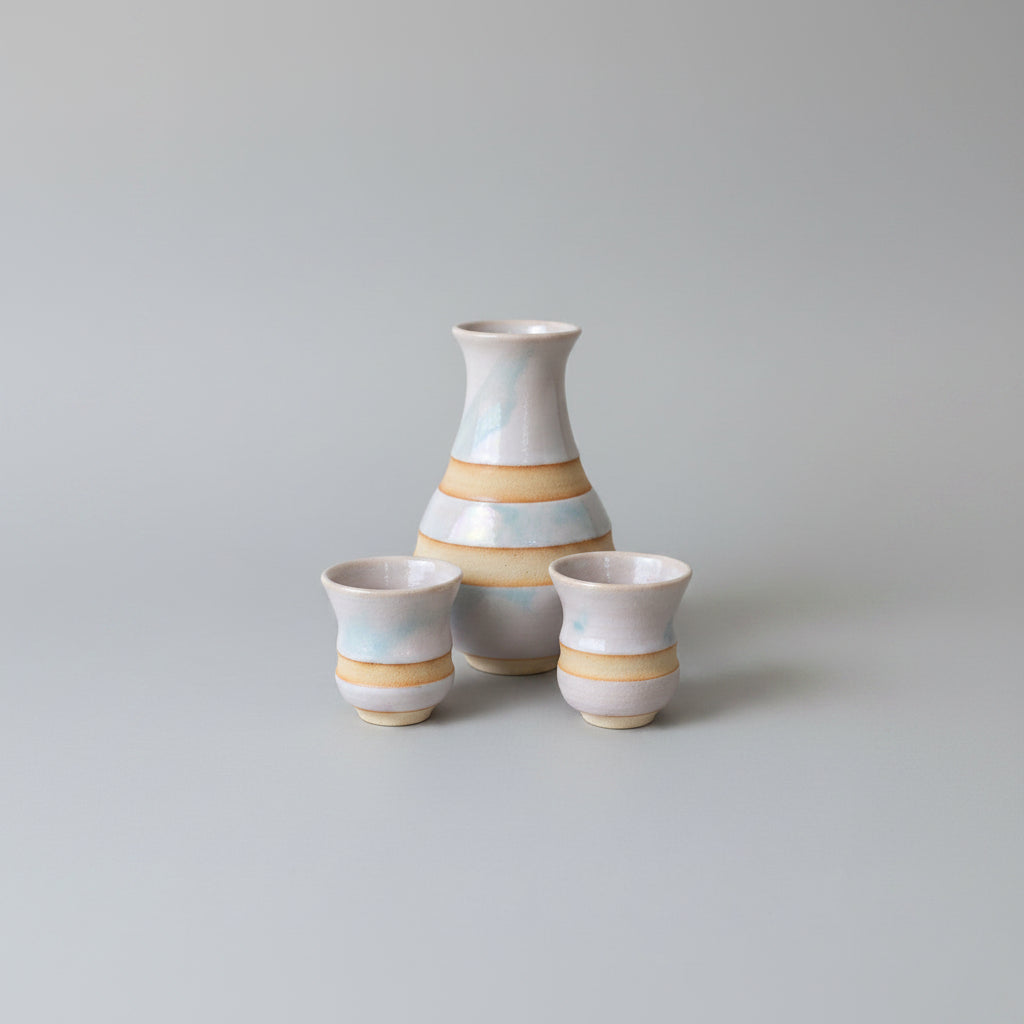 A sake-rset including a bottle  pourer, and two cups, in Hagi Clay.