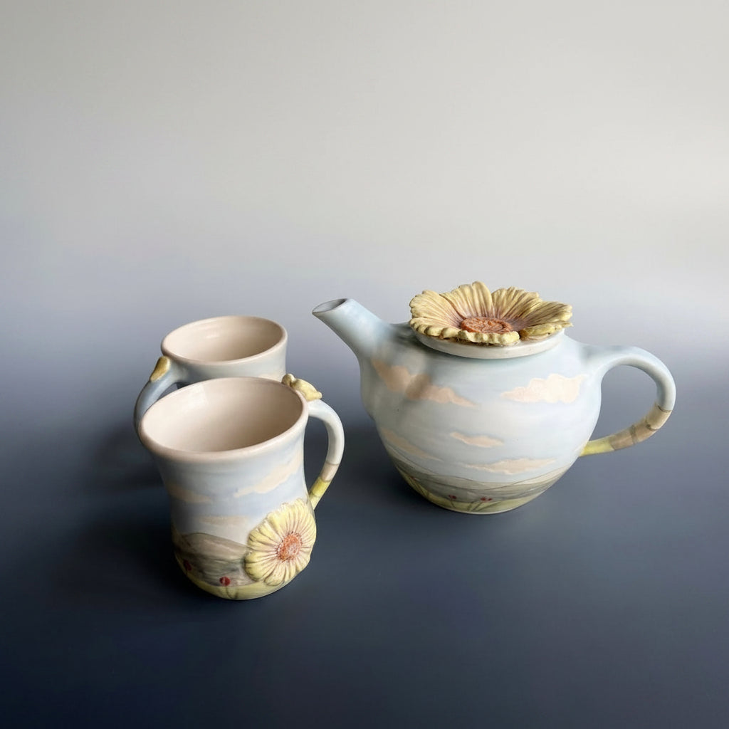 Ceramic teapot and two mugs with english country side designs in a semi gloss opague glaze.