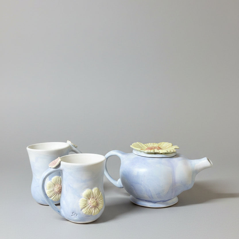 A English Heather coloured tea pot with two mugs.