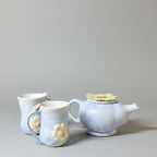 A English Heather coloured tea pot with two mugs.