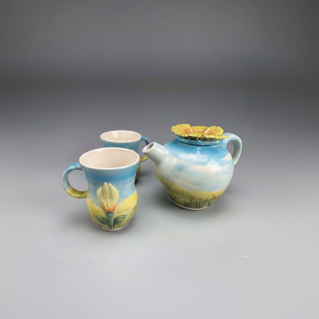 A hand decorated and hand throw tea set in stoneware clay, a ray of an English sunny day for you
