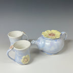 A English Heather coloured tea pot with two mugs.