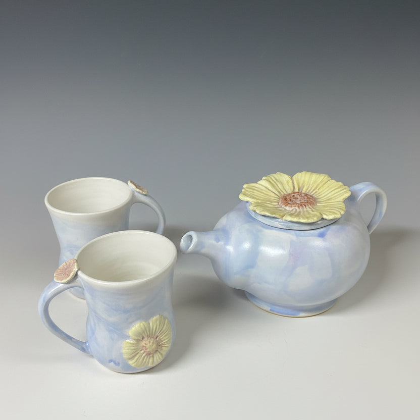 A English Heather coloured tea pot with two mugs.