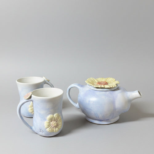 A English Heather coloured tea pot with two mugs.
