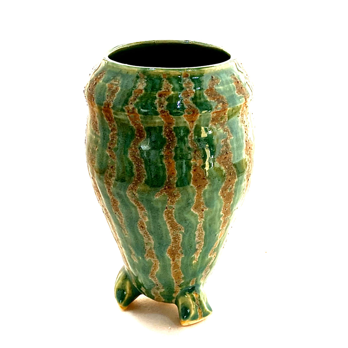 A large three footed green vase