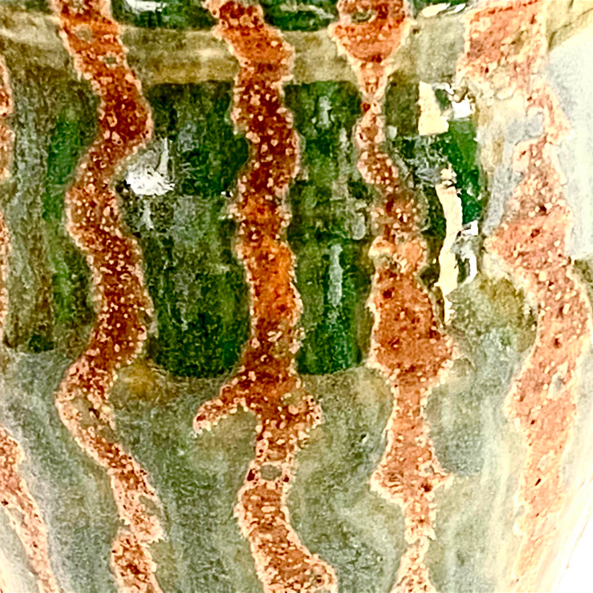 A large three footed green vase