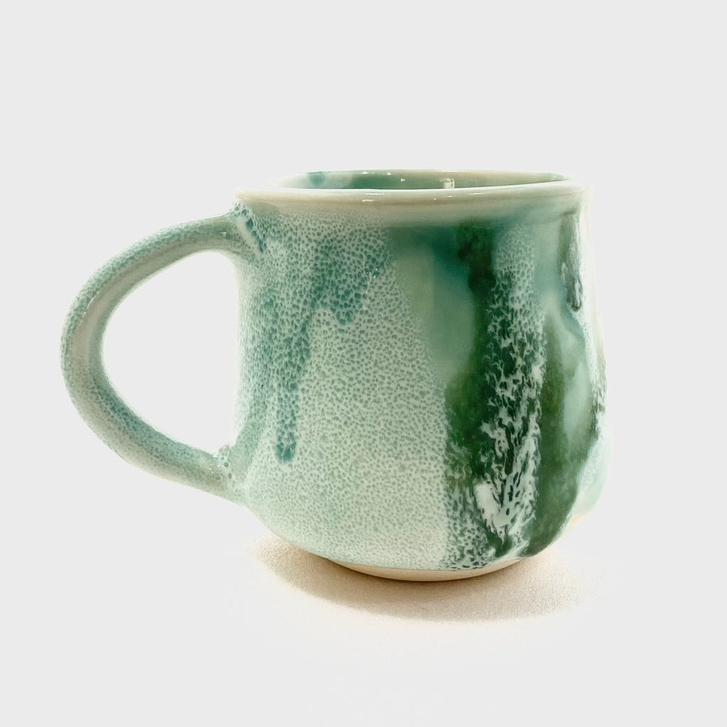 A green big handled Mug