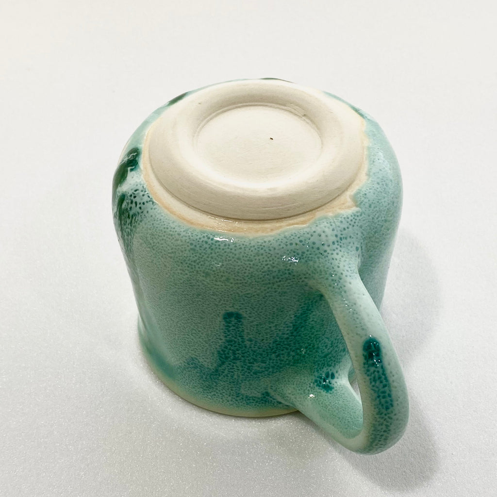 A green big handled Mug