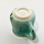 A green big handled Mug
