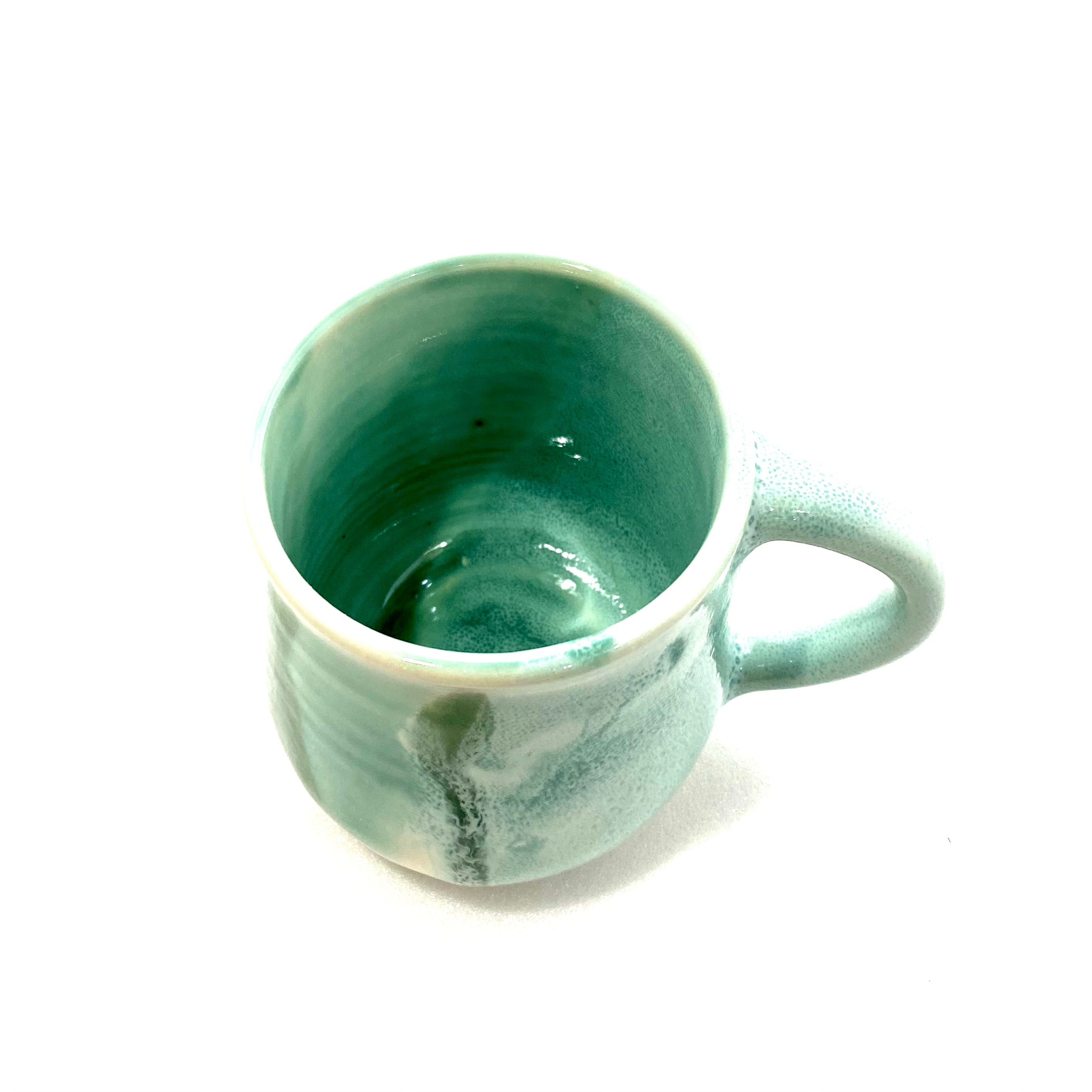 A green big handled Mug