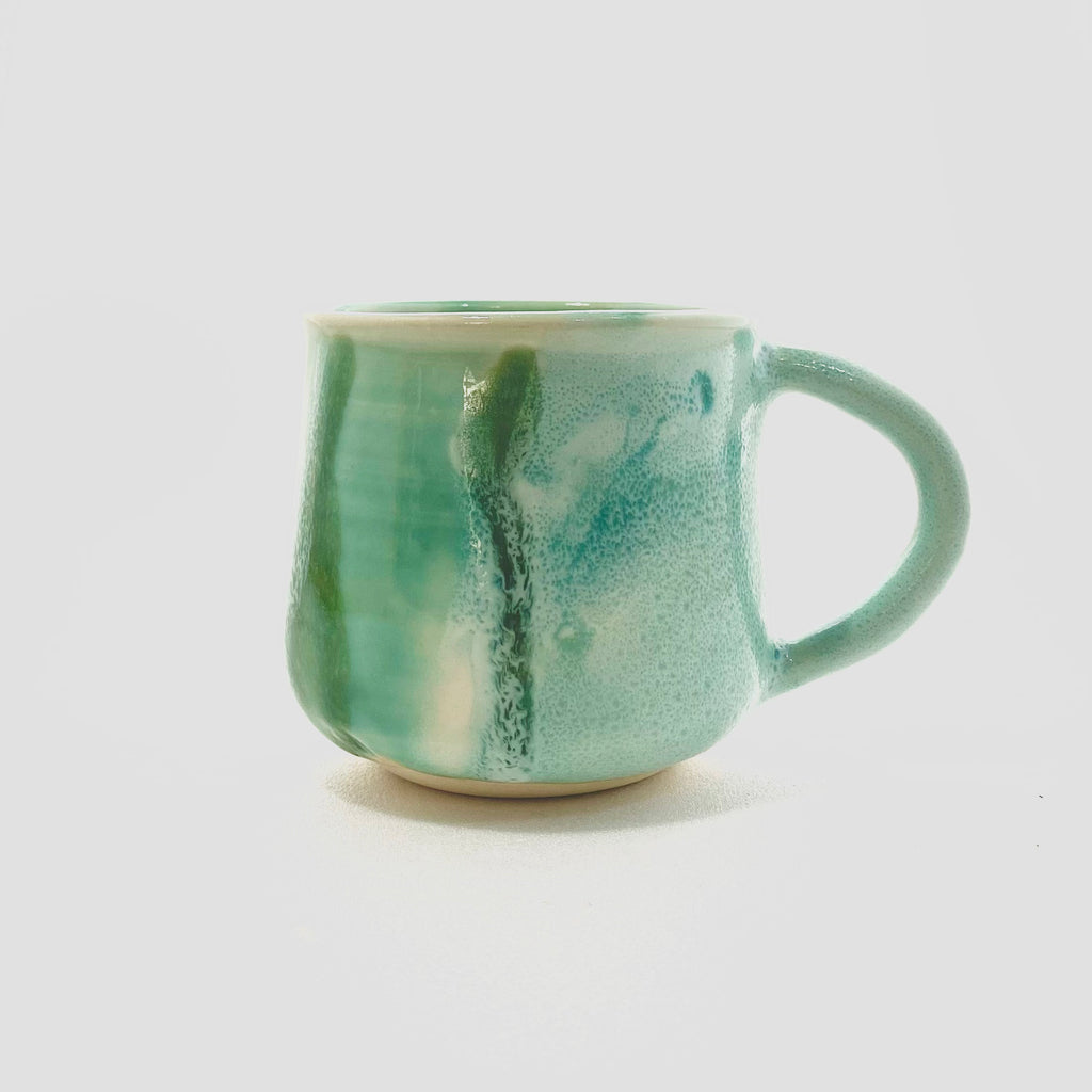 A green big handled Mug