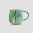 A green big handled Mug
