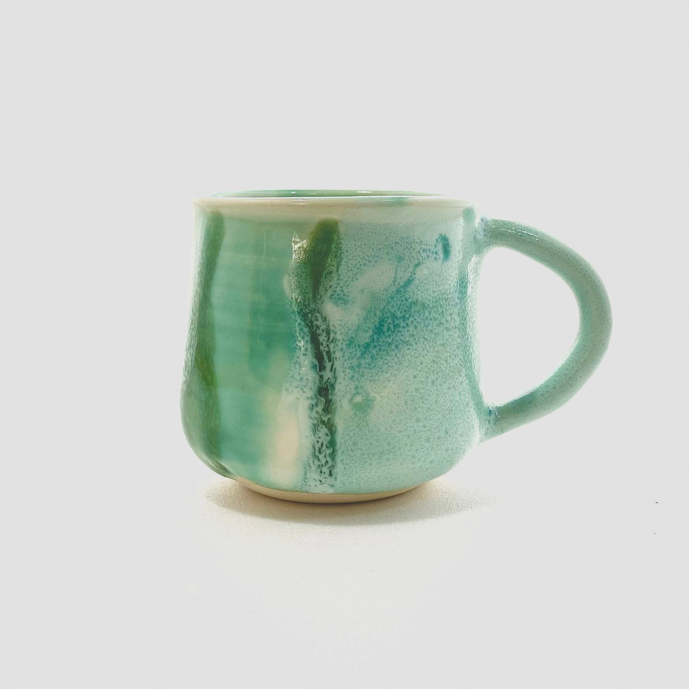 A green big handled Mug